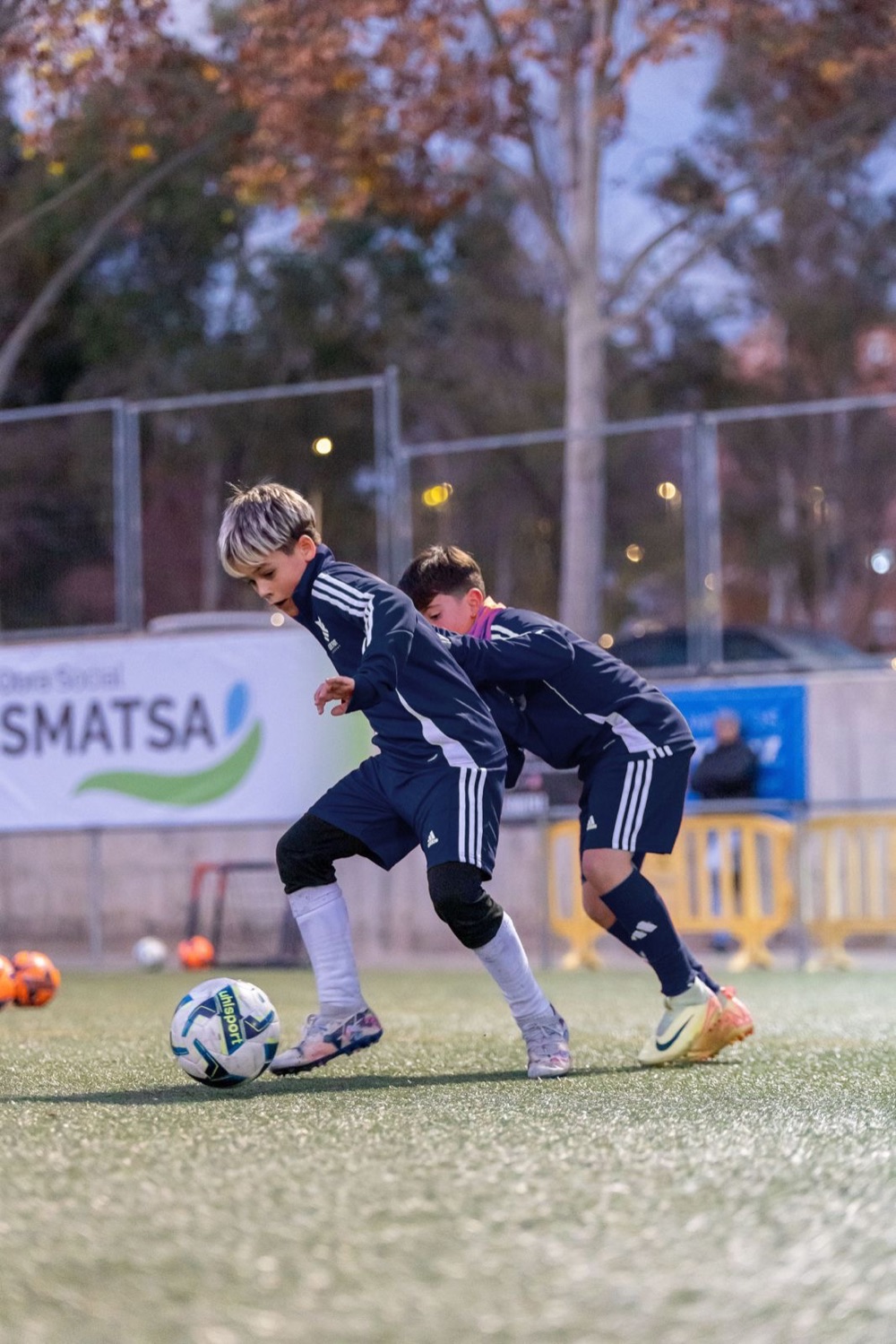Dos jugadores disputando el balón en un entrenamiento en pareja